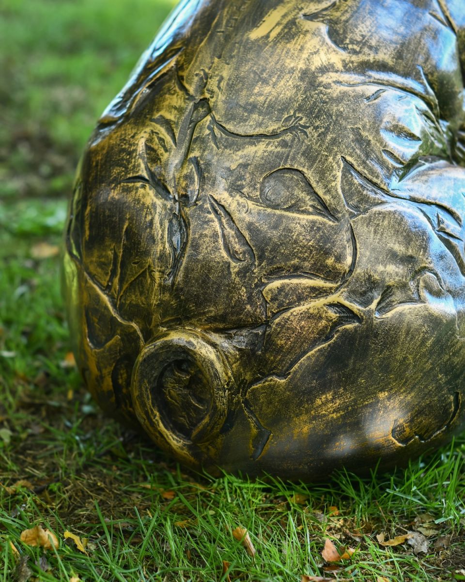 Close up of curly tail detail on farmyard patio ornament