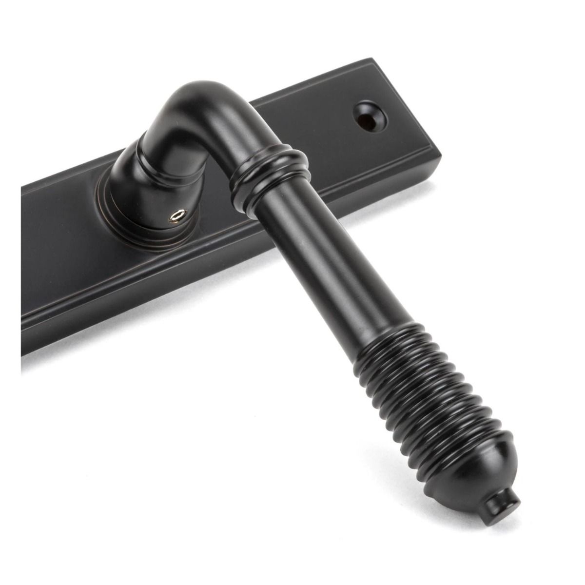 Close up of the Handle for The Reeded Slimline Lever Espagnolette Door Latch in Aged Bronze