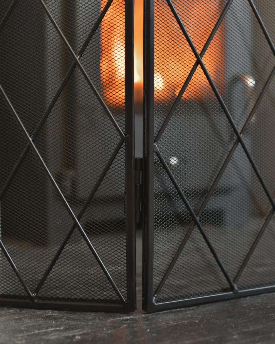 Close Up Of The Hinges On The Ornate Black Fire Guard 