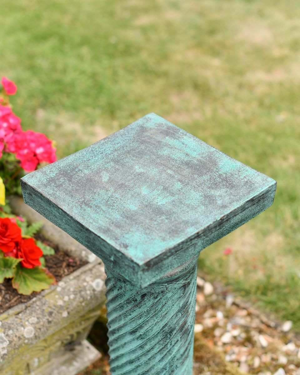 Close up of rustic verdigris finish on garden plinth