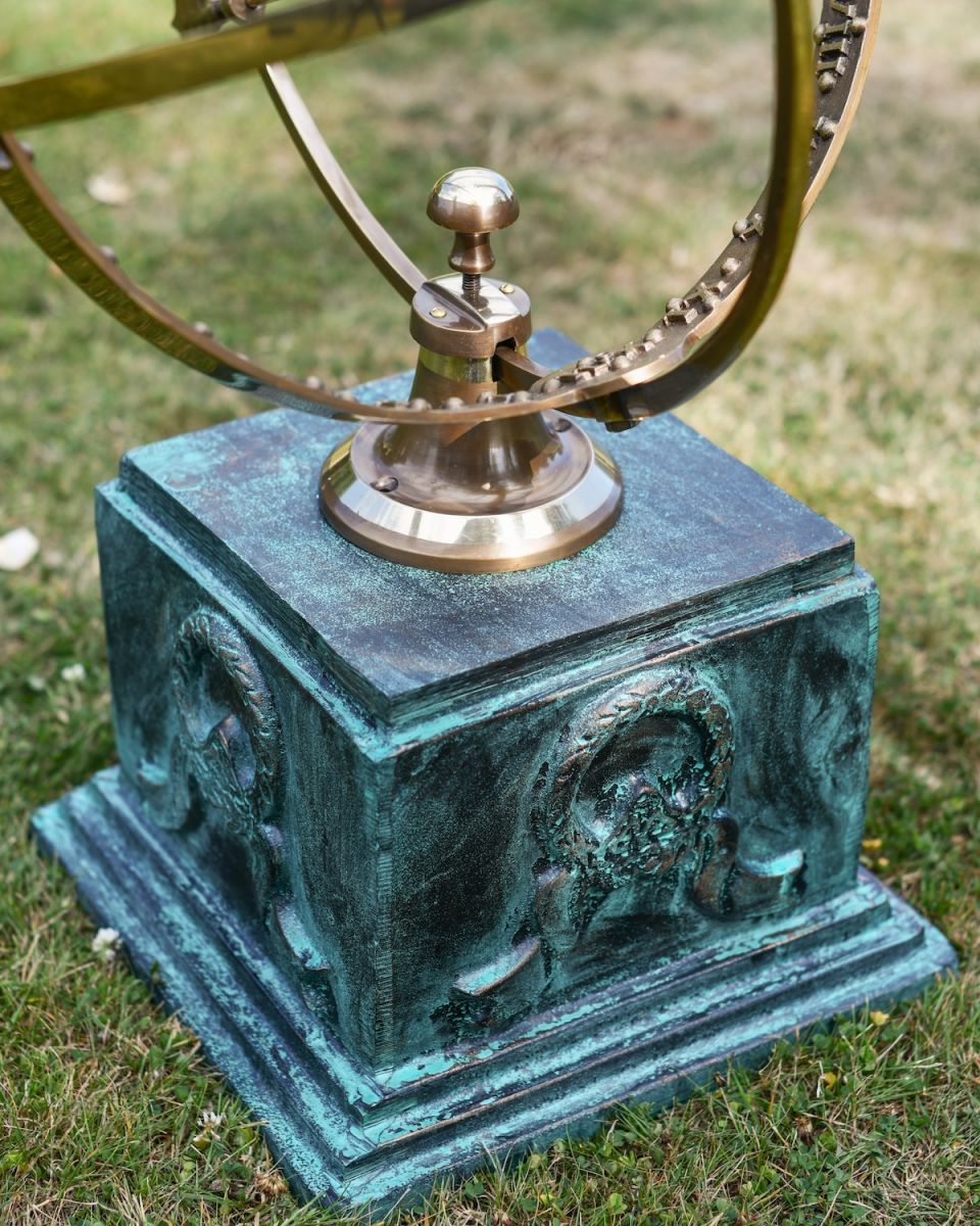 close up of verdigris finish on garden sundial column