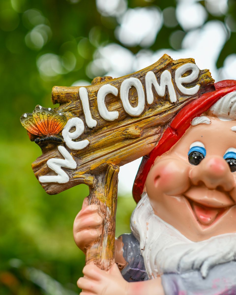 Close up of intricate detail on welcome sign on colourful garden gnome ornament