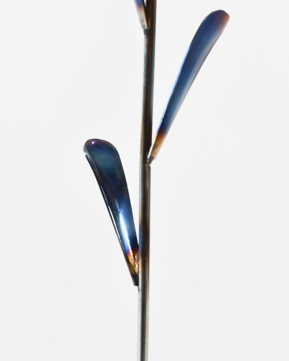 Close up of stem detail on recycled metal tulip ornament Close up of stem detail on recycled metal tulip ornament