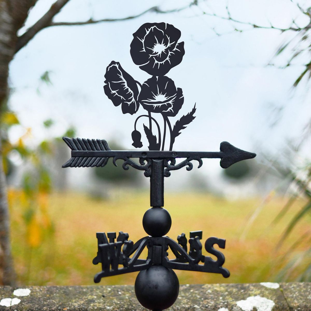 Cluster of Poppies Weathervane Being Used on the Top of a Roof Cluster of Poppies Weathervane Being Used on the Top of a Roof