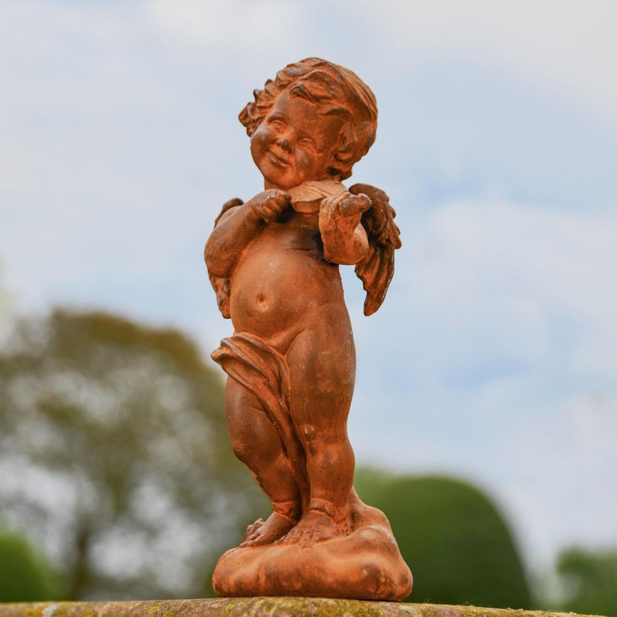 Rustic Cast Iron Winged Cherub with Violin Sculpture in Garden Rustic Cast Iron Winged Cherub with Violin Sculpture in Garden