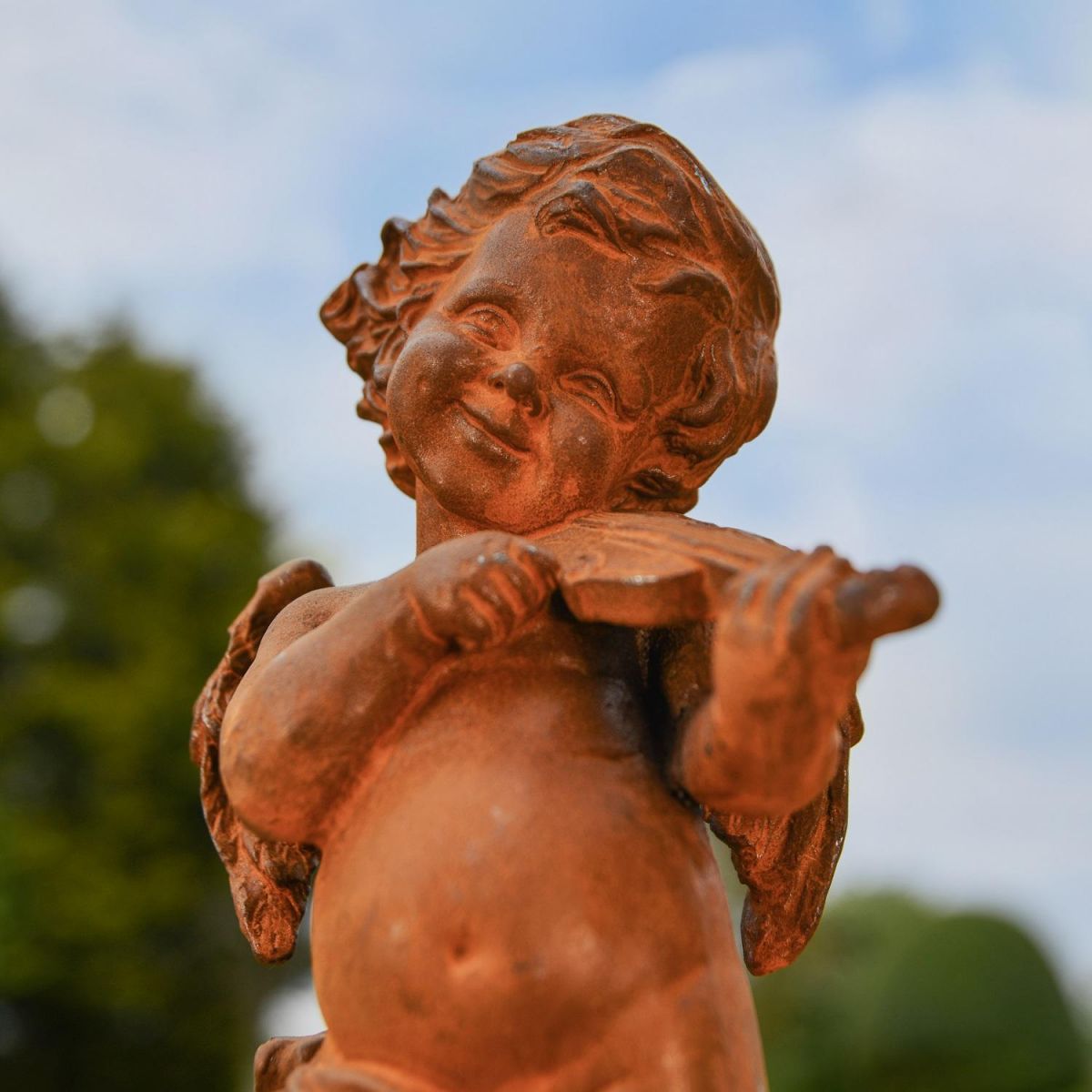 Close up of Cherub with Violin Garden Sculpture  Close up of Cherub with Violin Garden Sculpture