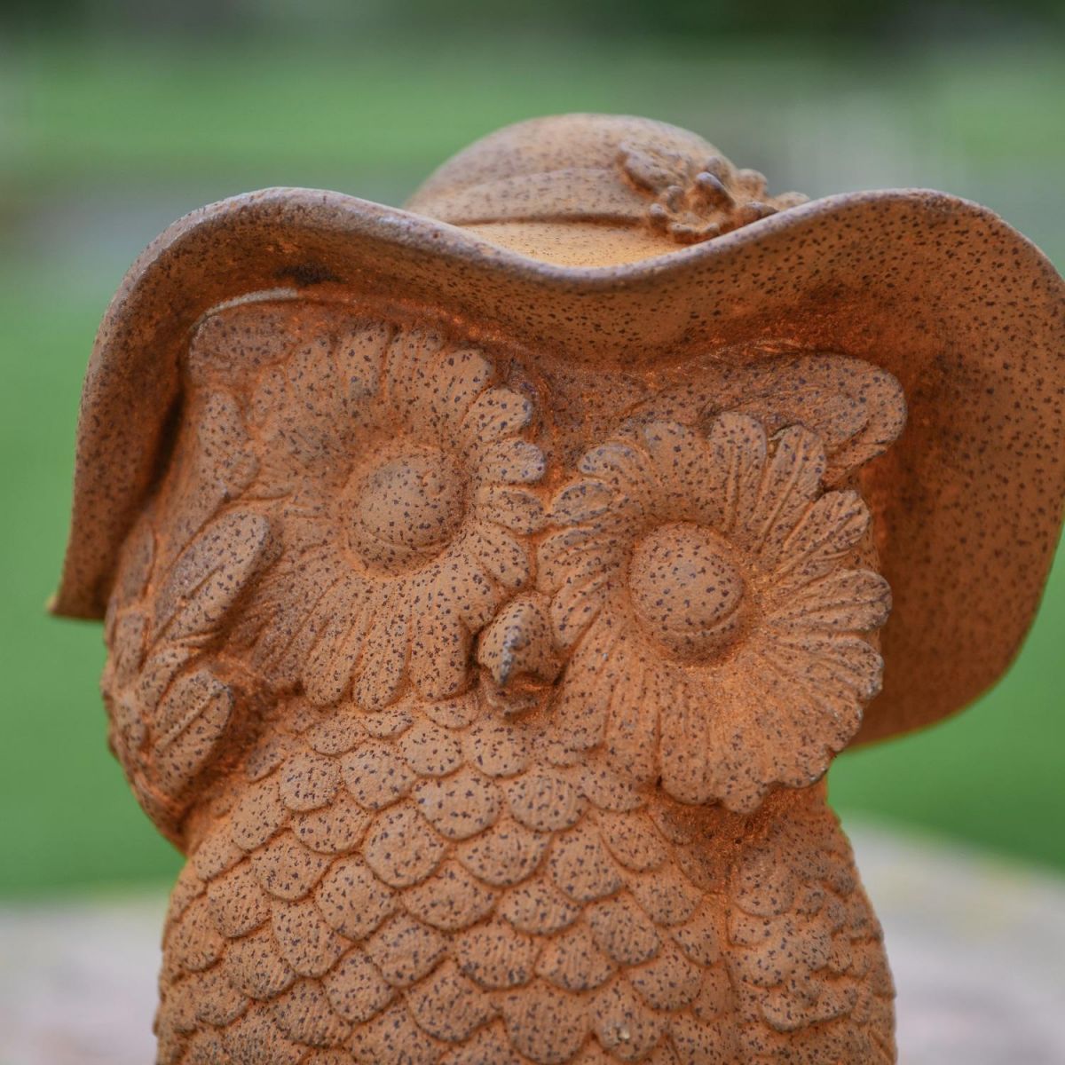 Close up of Daisy Glasses & Hat on Rustic Owl Garden Sculpture  Close up of Daisy Glasses & Hat on Rustic Owl Garden Sculpture