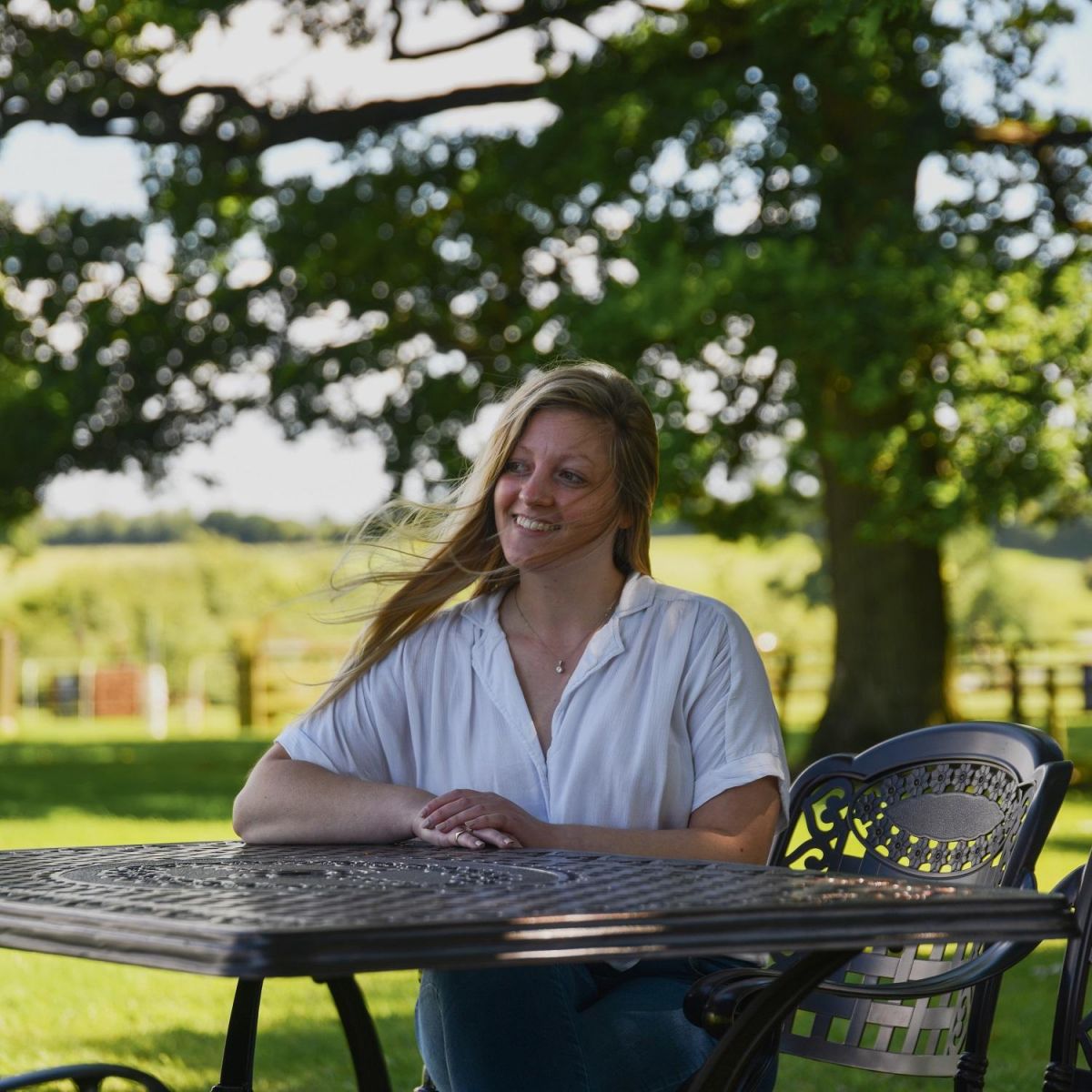 Female seated at Hestercombe Furniture Set 