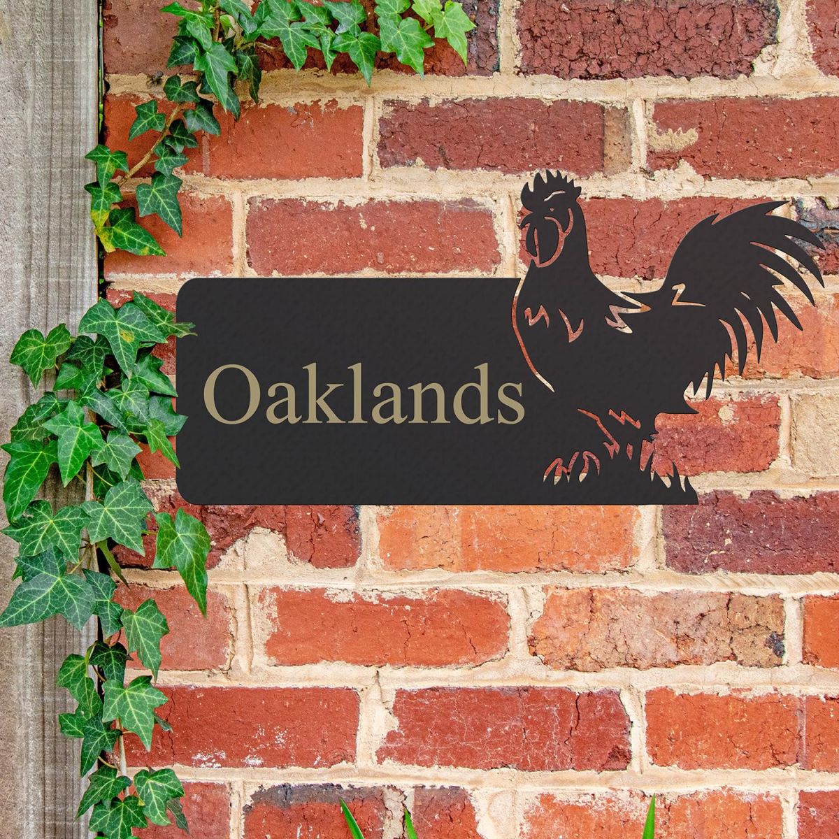Cockerel Iron House Name Sign in Use on a Brick Wall