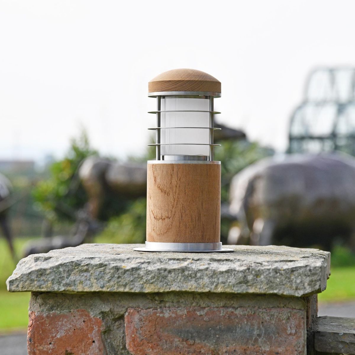Compact Wooden Bollard Light on a Brick Pillar in the Garden