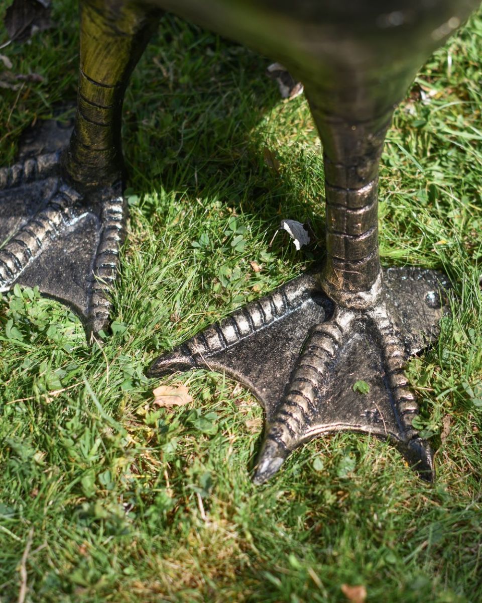 Close up of Black and Gold "Conqueror" Swan Sculpture feet