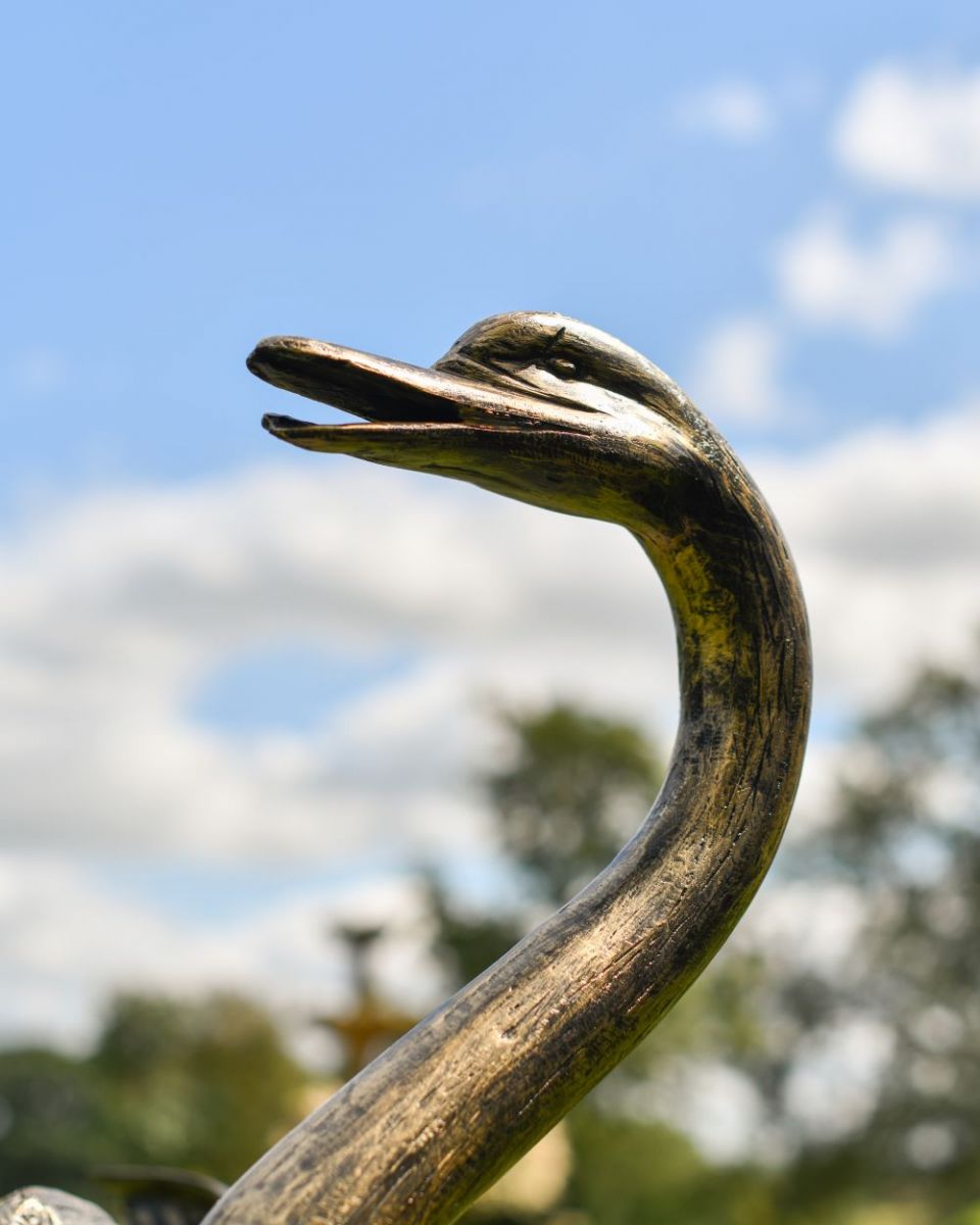 Close up of Black and Gold "Conqueror" Swan Sculpture head and neck
