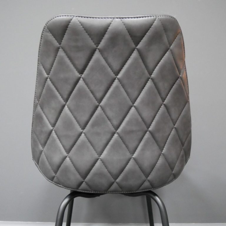 Close-up of the Back of the Grey Leather Dining Chair