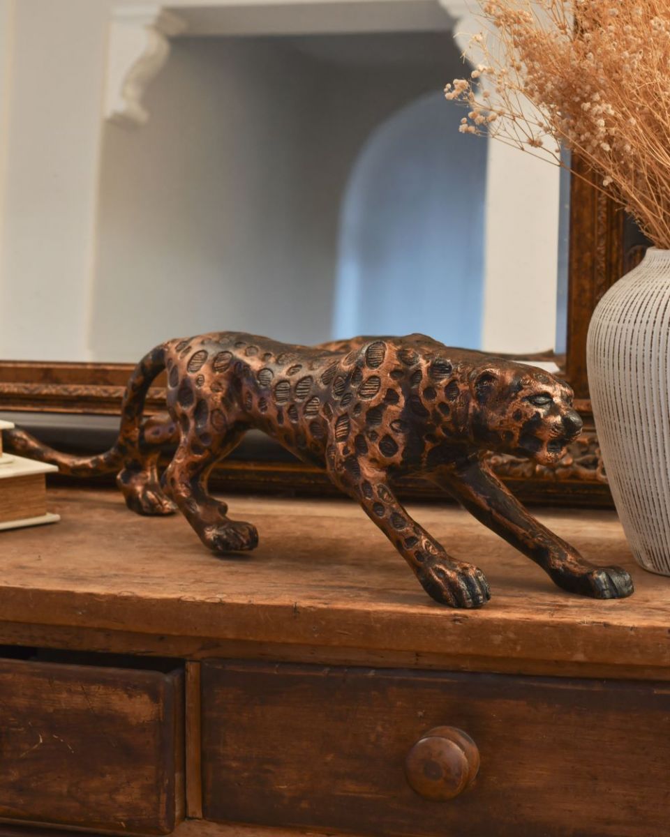 Three quarter view of copper leopard sculpture