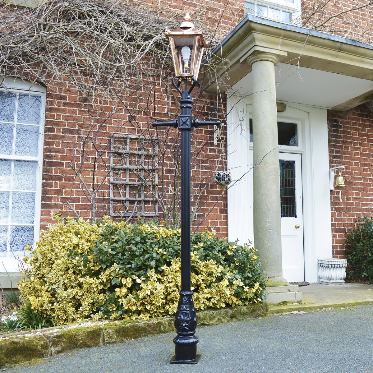 Copper Victorian lamp post outside house