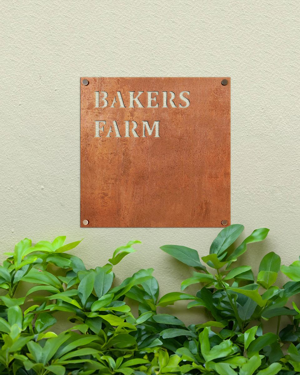 Rustic Steel Square House Name Sign Mounted onto a Painted House Wall