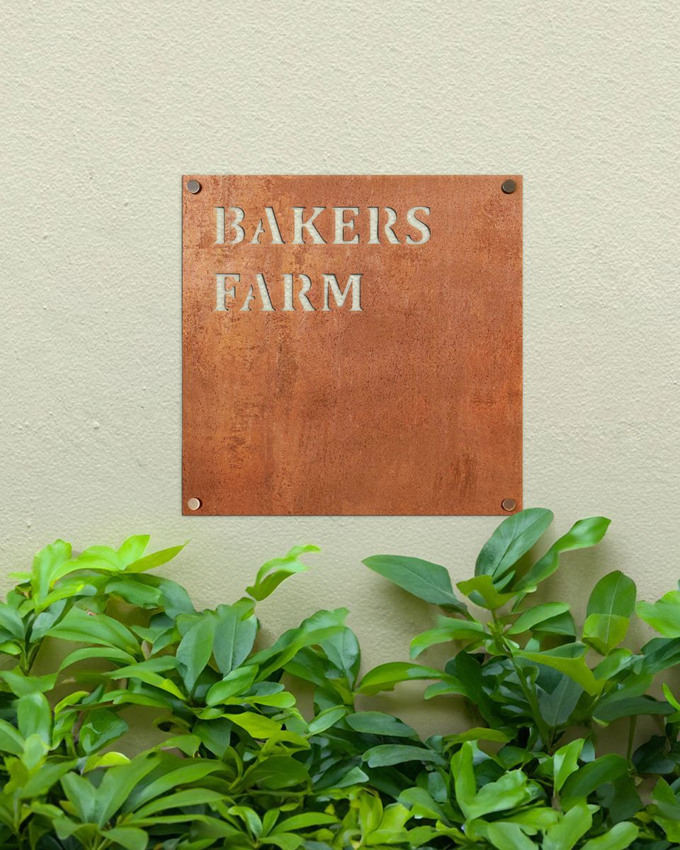 Rustic Steel Square House Name Sign Mounted onto a Painted House Wall