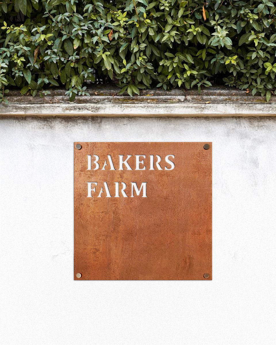 Corten Steel Square House Name Sign on a White Garden Wall