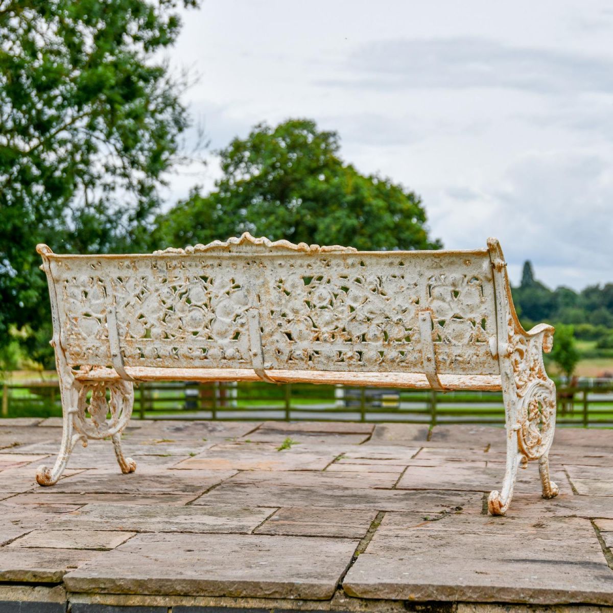 Rear view of Antique Cream Cast Iron Ornate Leaf and Scroll Three Seater Bench