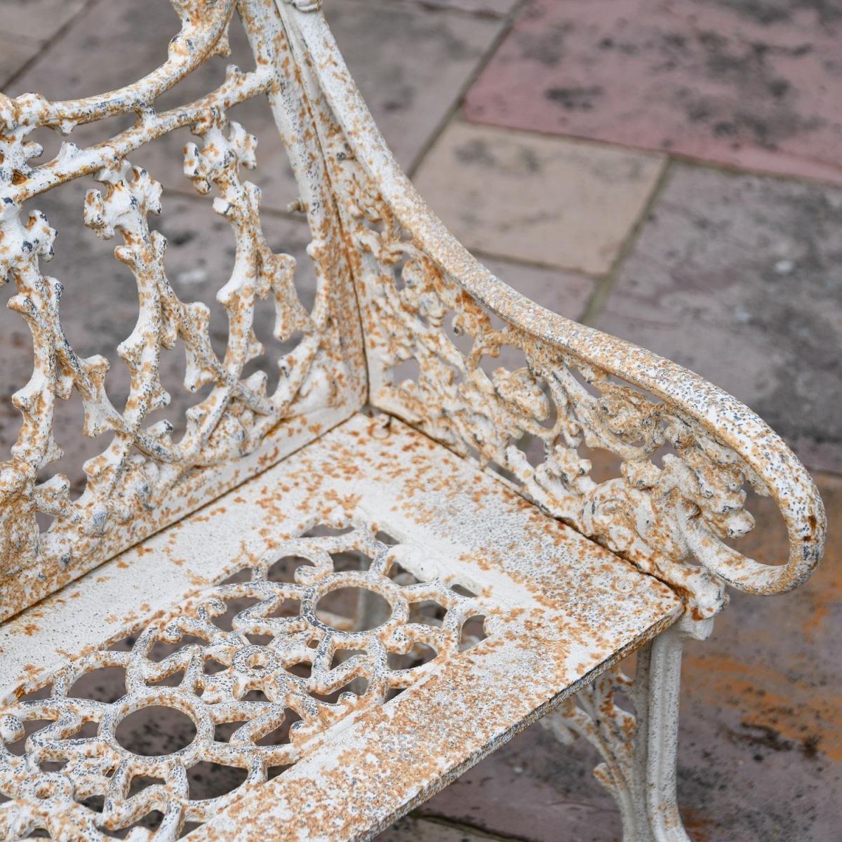 Close up of Antique Cream Cast Iron Two Seater Bench 