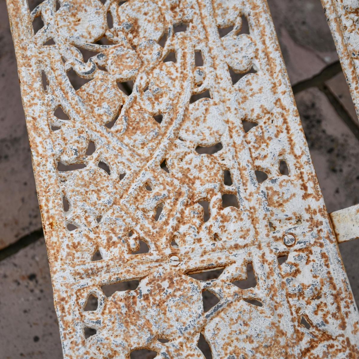 Close up of Antique Cream finish on seat of Cast Iron Bench