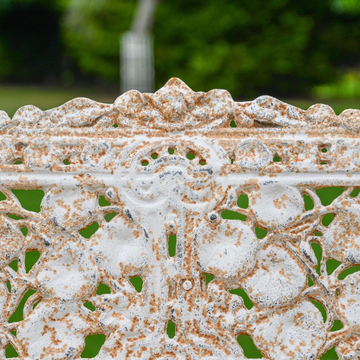 Close up of Antique Cream Cast Iron Three Seater Bench