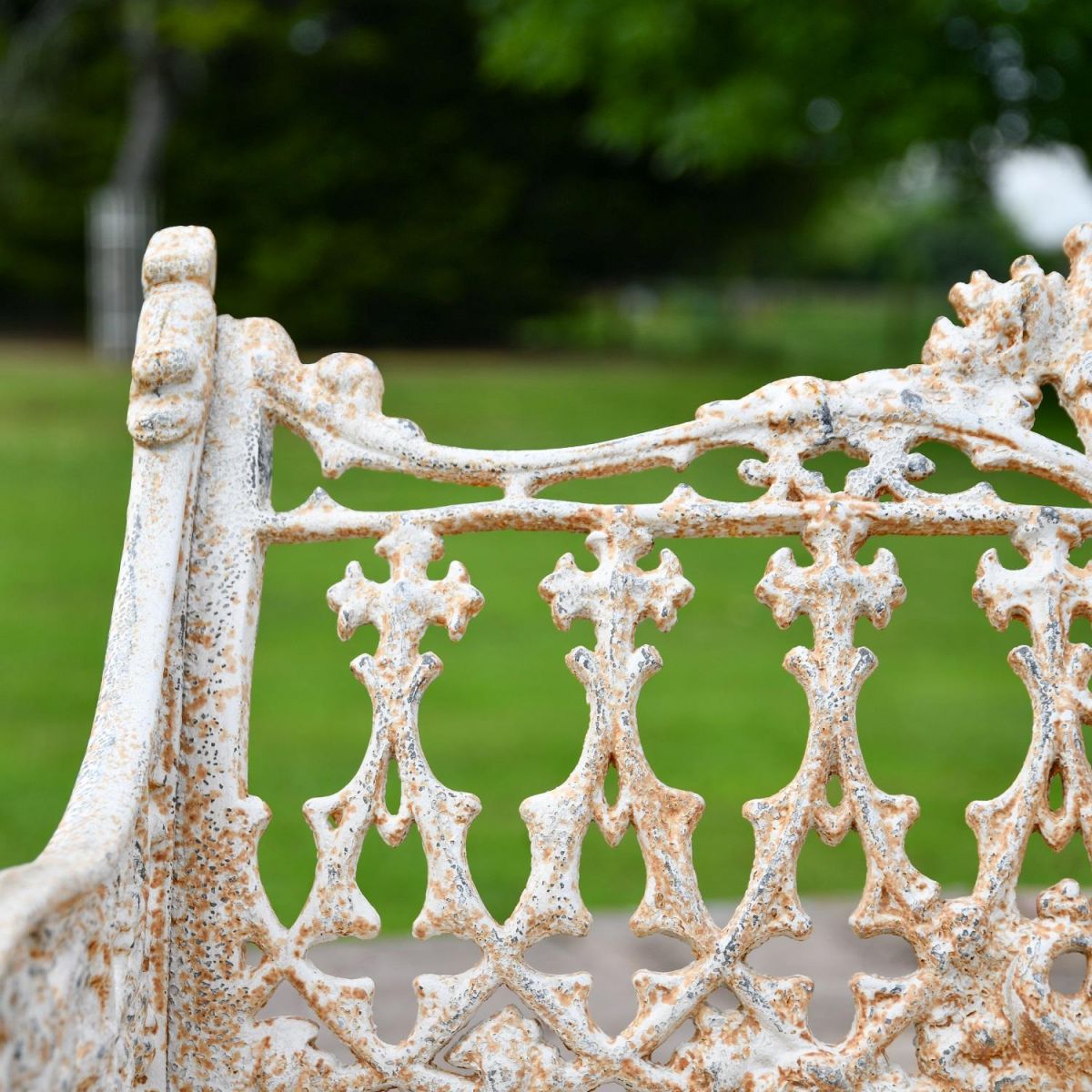 Close up of Antique Cream Cast Iron Garden Bench 