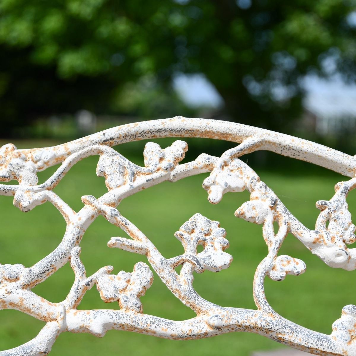 Close up of Antique Cream Cast Iron Tree Branch Bench 