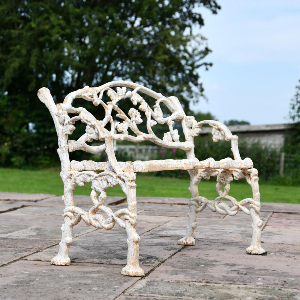 Side view of Antique Cream Cast Iron Tree Bench