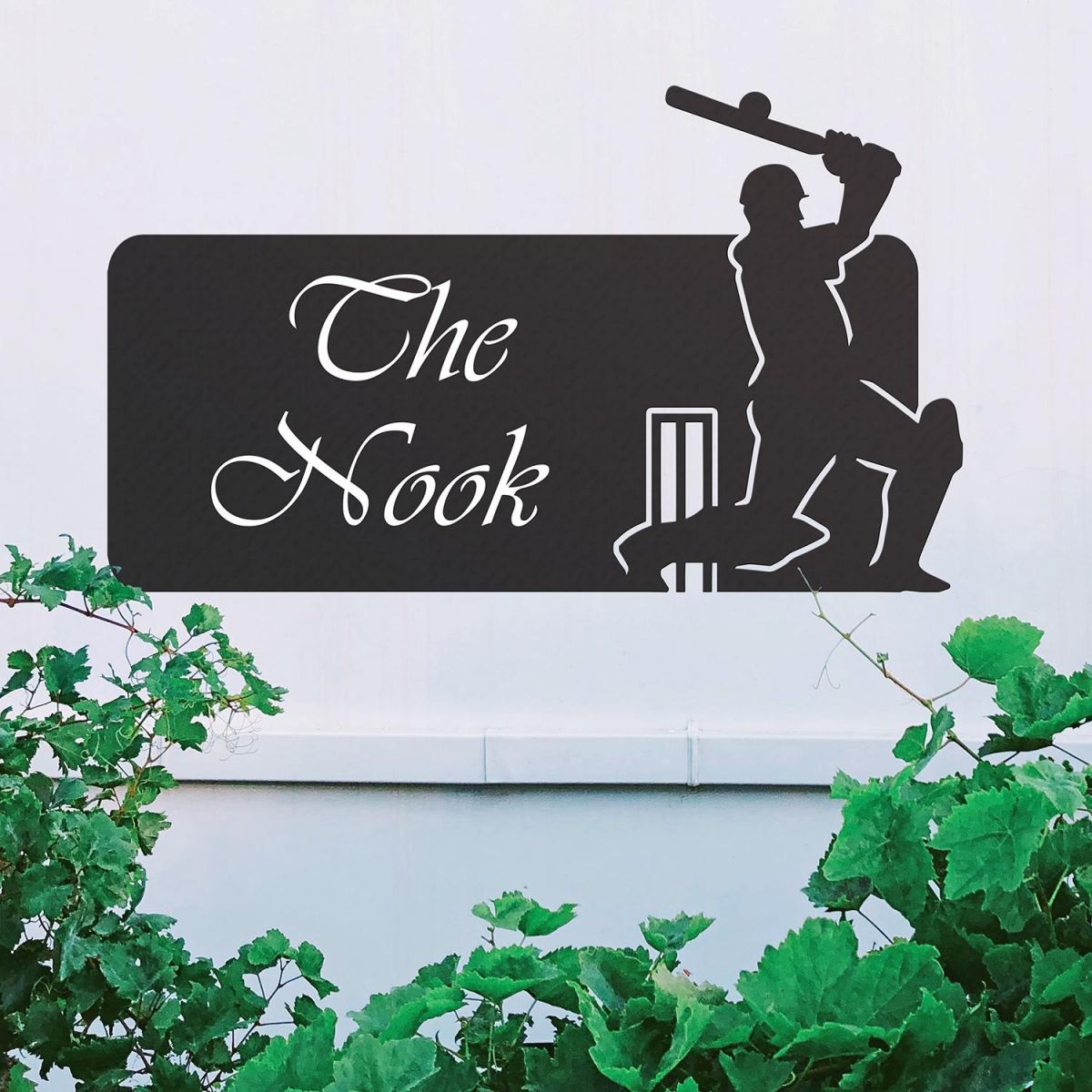 Black Cricket Player Iron House Name Sign on a White Wall