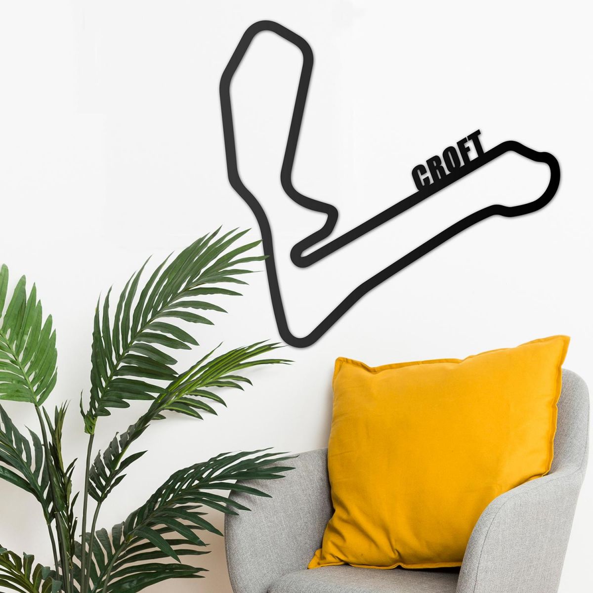 Croft Race Track Wall Art on the Wall Next to Plants