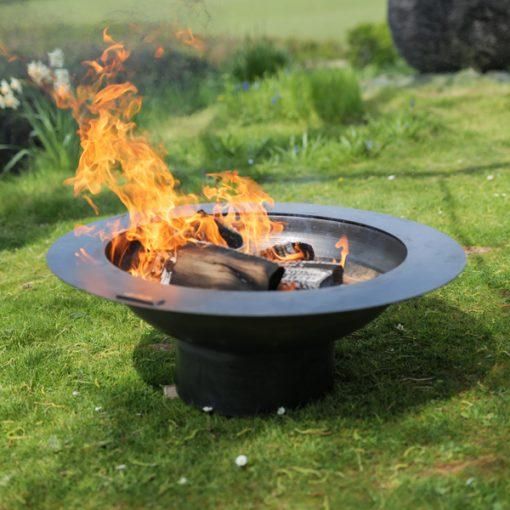 Curved Steel Bowl Fire Pit in Use in the Garden
