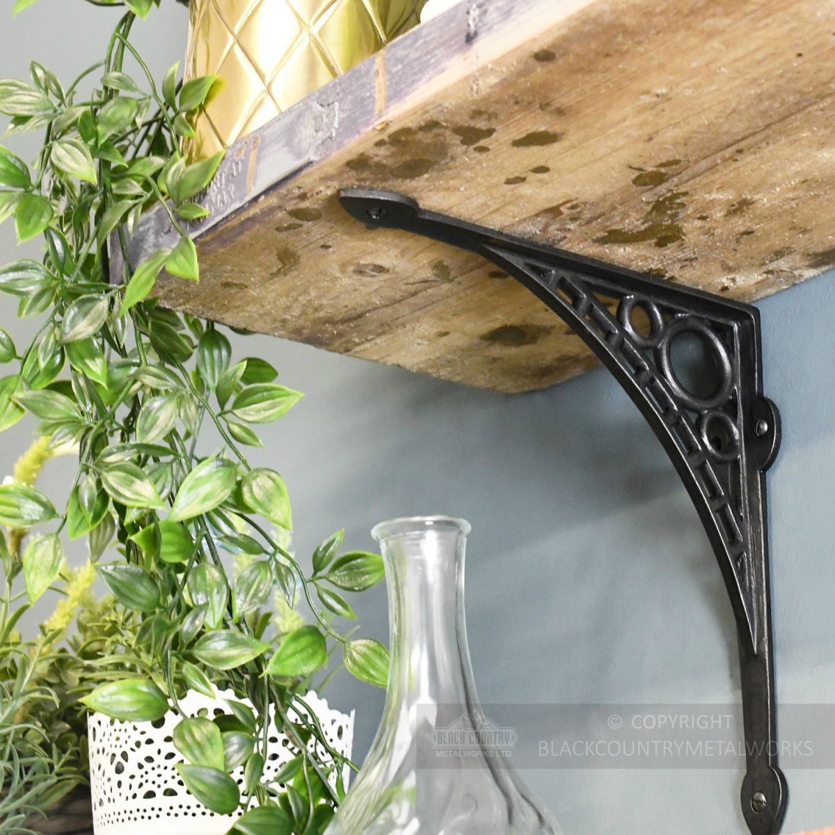 Dark Iron Shelf Bracket Holding Up Wooden Shelf