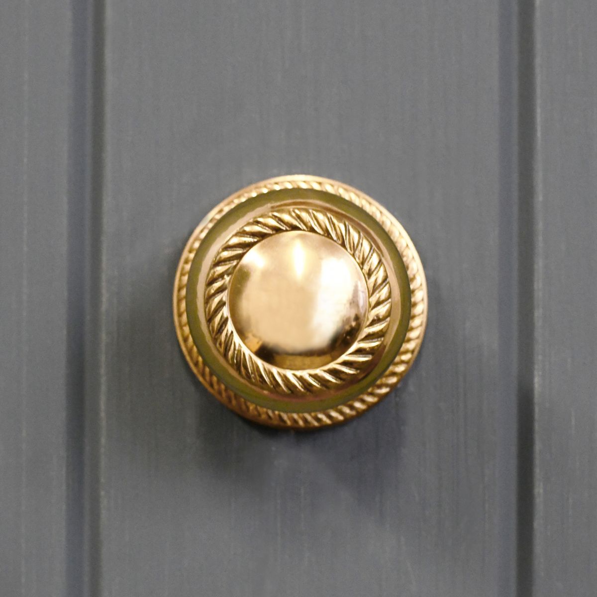 Brass centre door knob on grey door Brass centre door knob on grey door