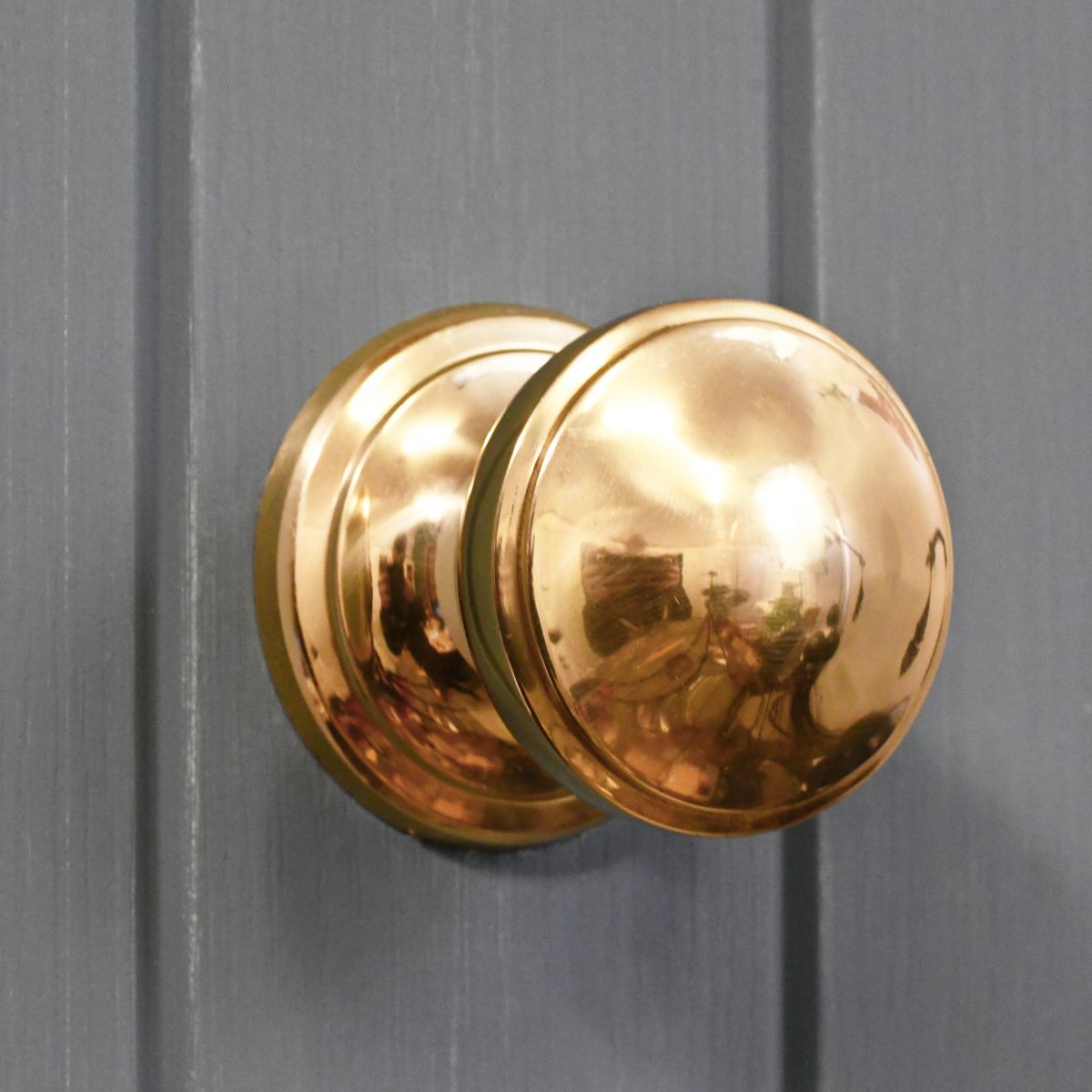 Polished brass round centre door knob