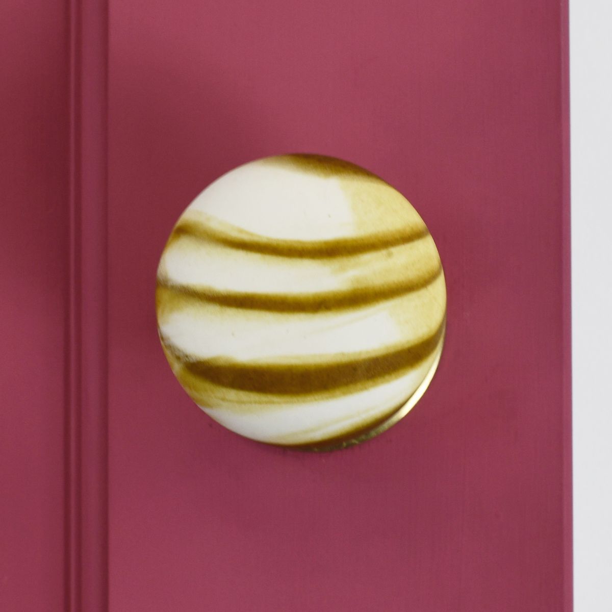 Ceramic stone effect door knob on pink door