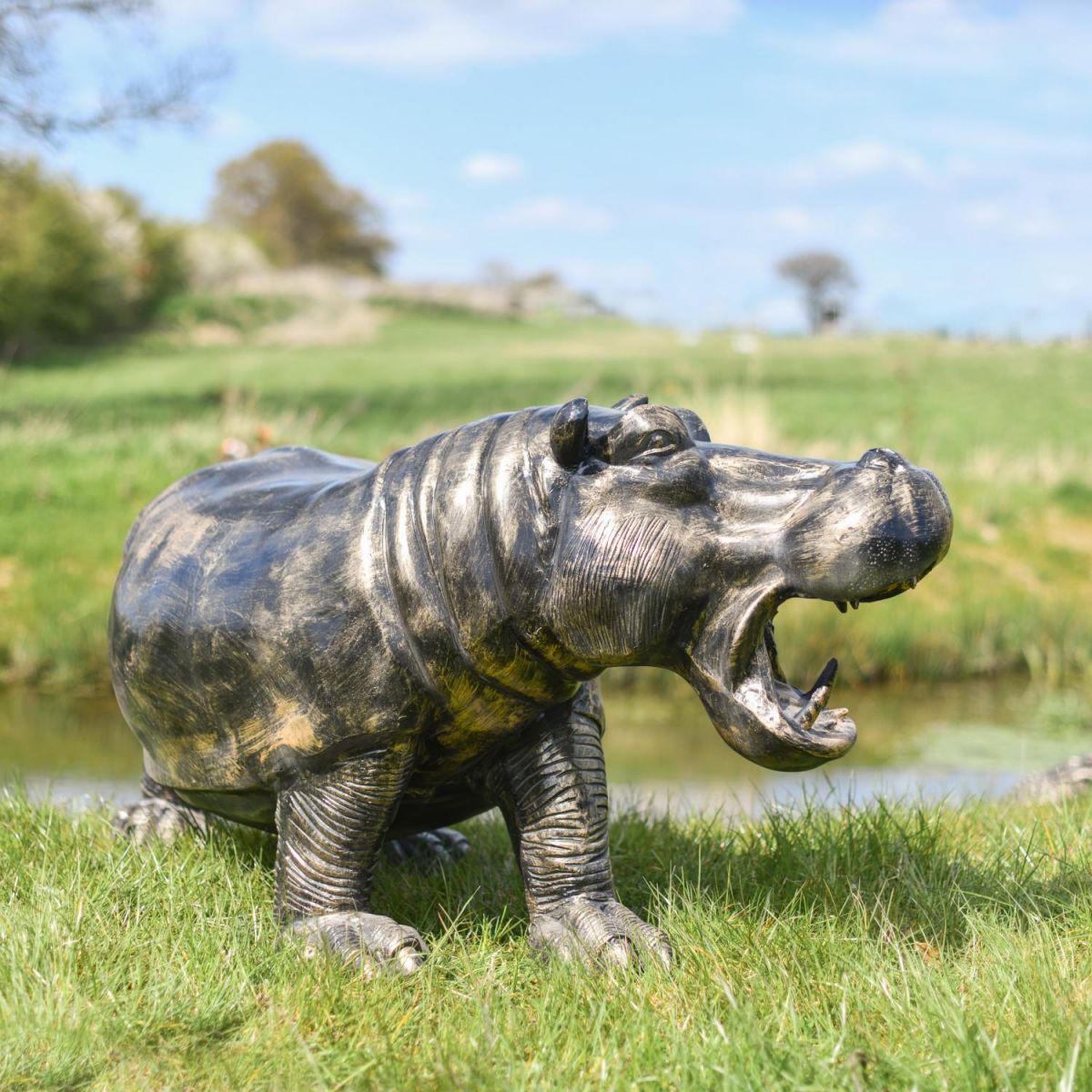 Deluxe Cast Aluminium Freestanding Wild Hippo Garden Sculpture in Antique Gold in Situ