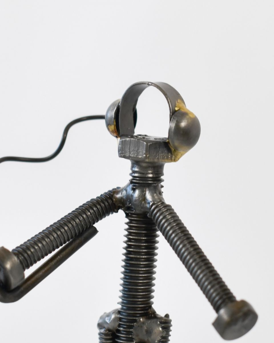 Close up of intricate person detail on recycled metal art sculpture