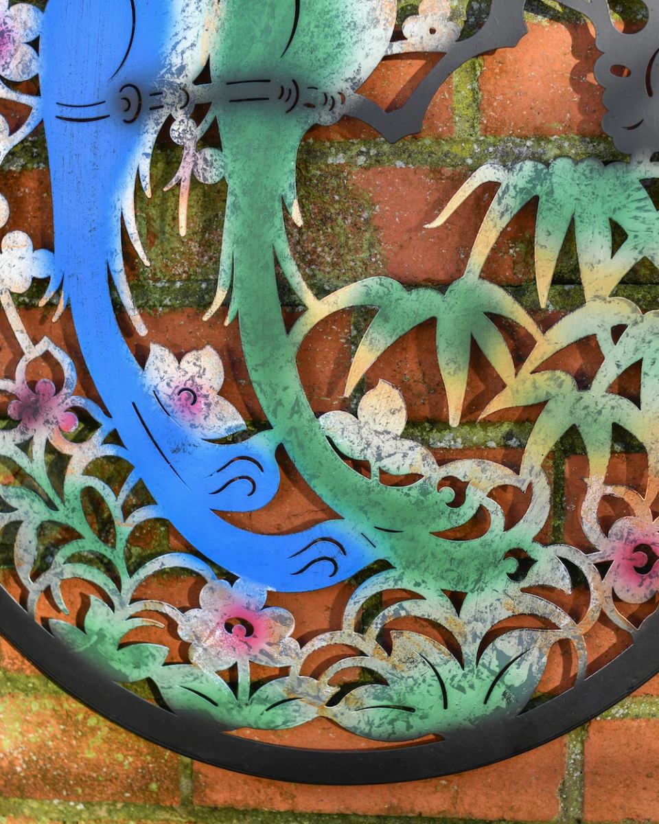 Close up of colourful steel detail on garden wall art 