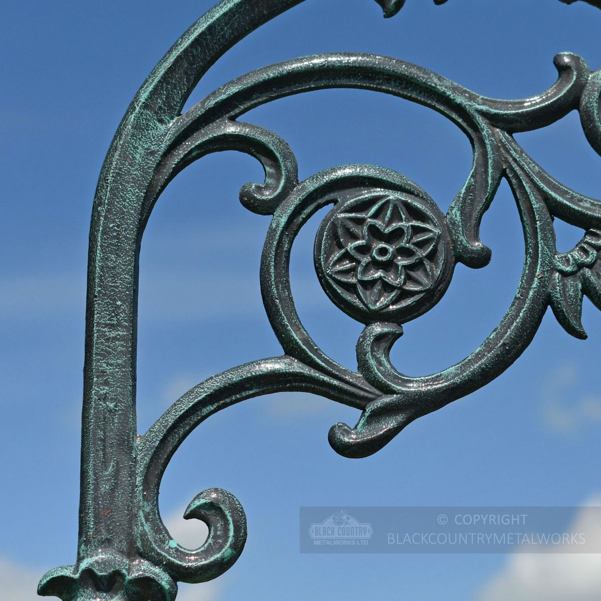 Detailed lamp post bracketry in rustic blue finish