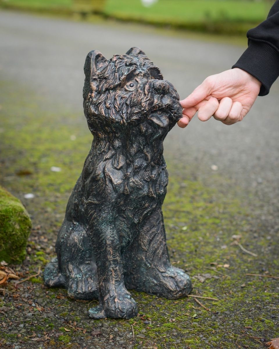 Digital illustration of ‘Baxter’ the Yorkshire Terrier Garden Sculpture in Cast Aluminium - Verdigris with hand in shot for scale