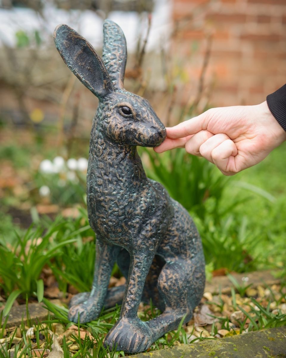 Digital illustration of ‘Hark’ Cast Aluminium Hare Garden Sculpture - Verdigris with hand in shot for scale