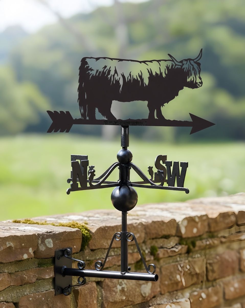 Digital illustration of highland cow weathervane mounted on a stone wall