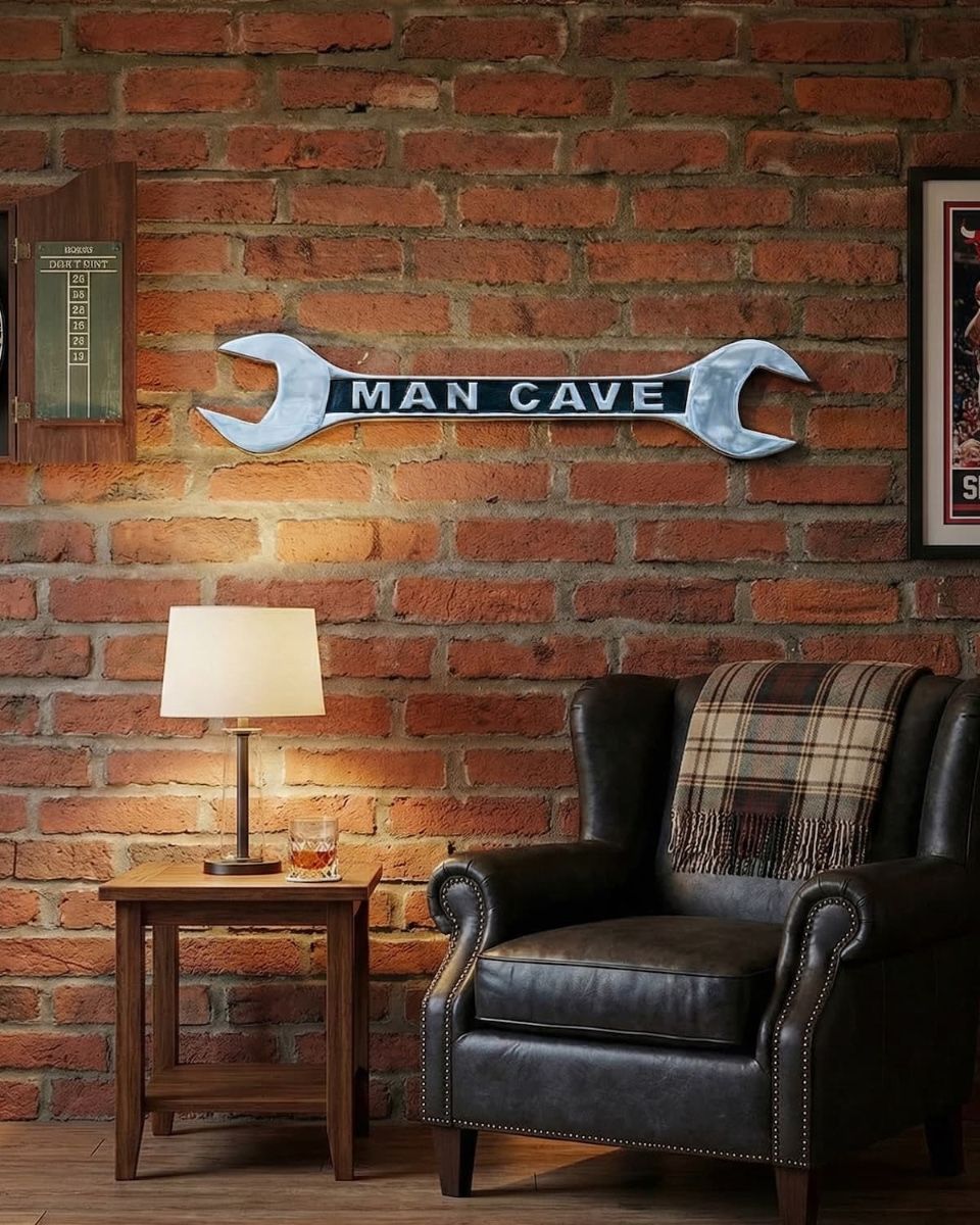 Digital Illustration of "Man Cave" Spanner Sign in Cast Aluminium Wall Art Mounted on a Brick Wall with Lounge Chair and Lamp