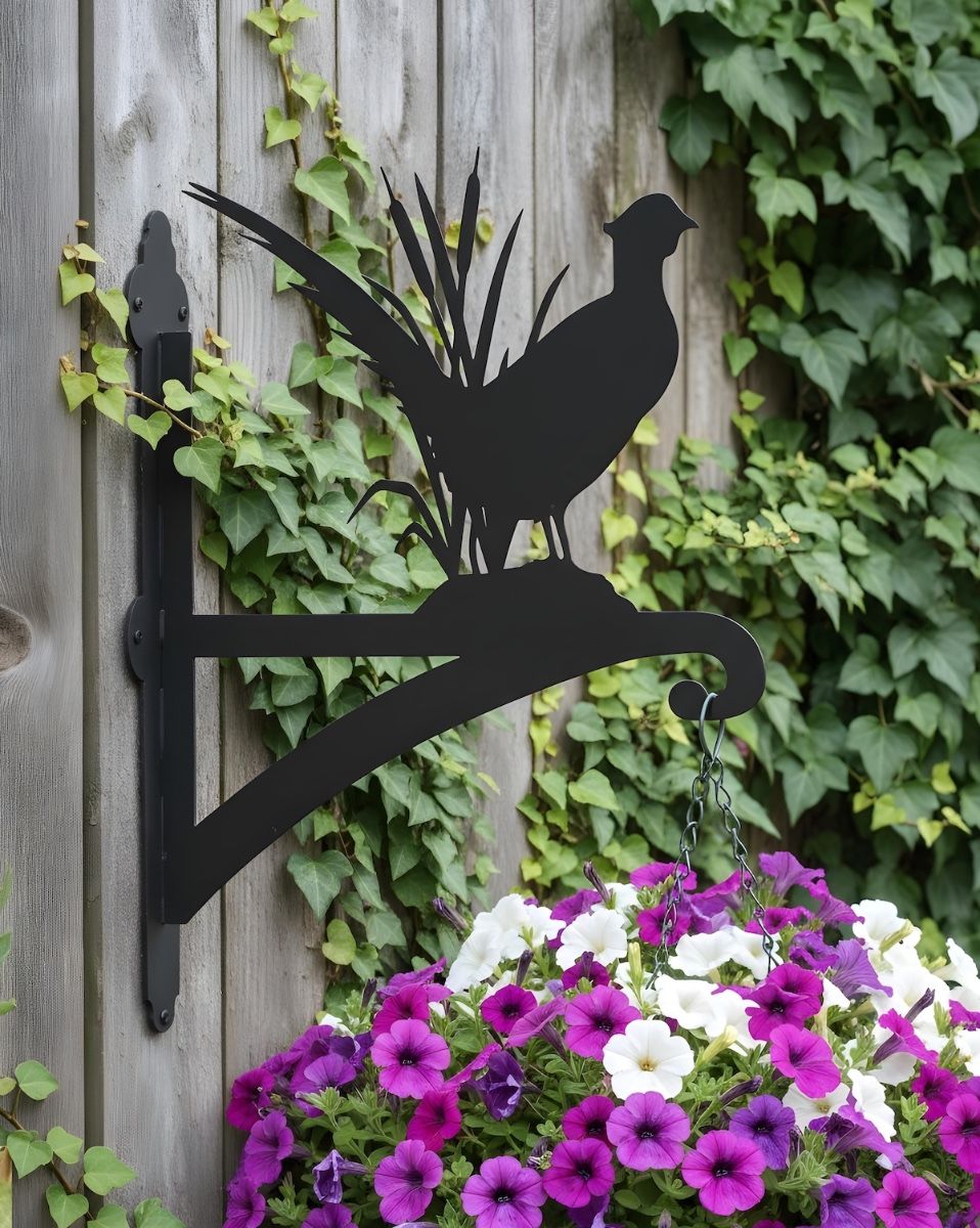 Digital Illustration of the Pheasant Iron Hanging Basket Bracket Mounted on an Ivy Covered Garden Fence
