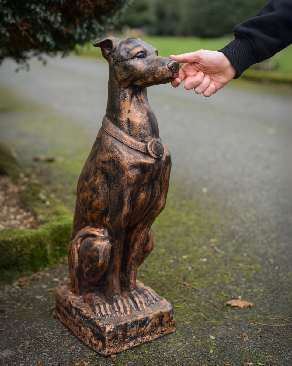 Digital illustration of "Rocket" the Sitting Greyhound in Cast Aluminium - Copper with hand in shot for scale