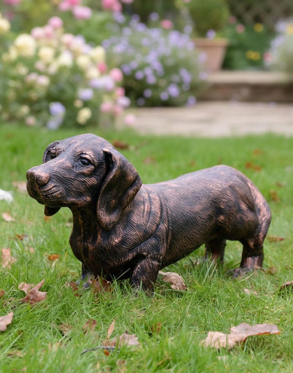 Digital Illustration of "Rolo" the Sausage Dog Cast Aluminium Garden Sculpture in a Copper Finish positioned on a Leaf Covered Lawn