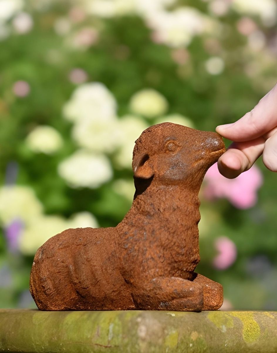 Digital illustration of Rustic Cast Iron Lying Down Lamb with hand in shot for scale