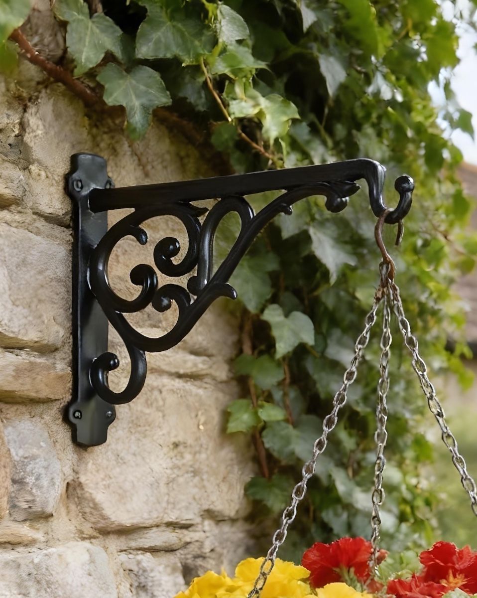 Digital illustration of Scroll Effect Hanging Basket Bracket 25 x 36cm mounted on a stone wall