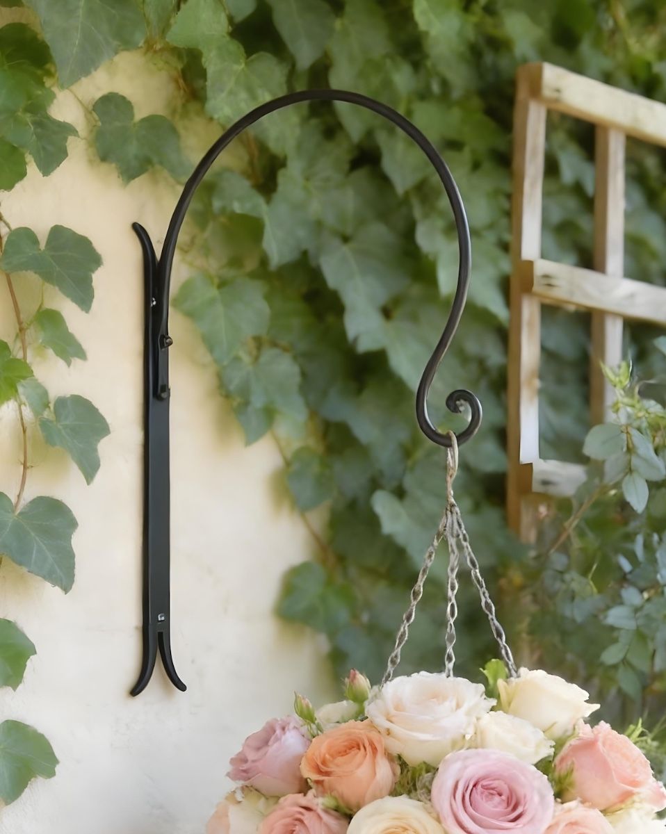 Digital illustration of ’Shepherds Crook’ Hanging Basket Wall Bracket - Black mounted on ivy covered wall